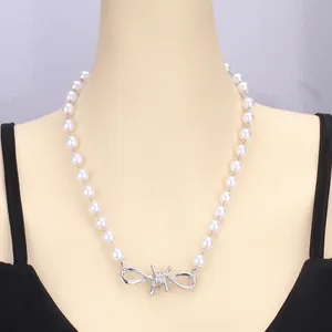 Punk style pearl necklace with silver barbed wire cross pendant on model mannequin