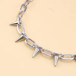 Punk silver-colored metal alloy chain with spiked studs and glossy finish on yellow base
