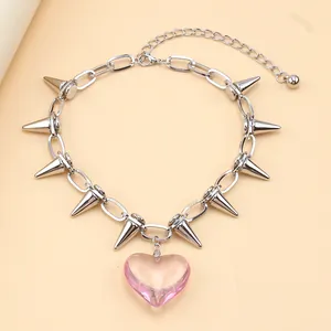 Detail of pink translucent heart pendant on a punk style silver spiked chain necklace