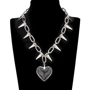 Gothic punk silver chain necklace featuring sharp spikes and a clear heart pendant