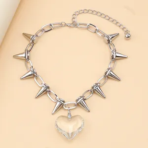 Detail of silver spiked chain necklace with large transparent heart pendant close-up