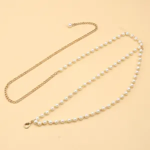 Detail of elegant pearl waist chain with adjustable gold metal link and lobster clasp