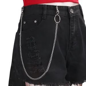 Detail of ripped black denim shorts with punk silver metal chain and belt ring