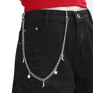 Close-up of a silver star and moon charms trousers chain on black denim jeans