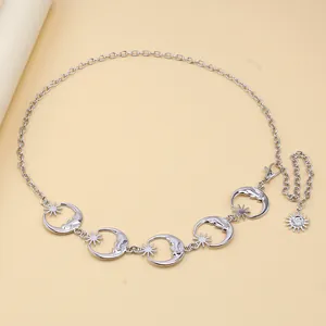 Detailed view of silver sun and moon star charms on a punk style metal hip chain belt