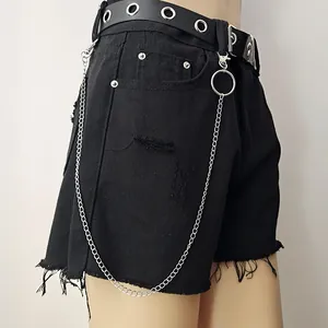 Black denim shorts with punk metal chain and silver eyelet belt in grunge street style