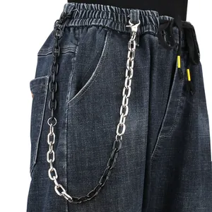 Detail of silver metal and black resin link trousers chain accessory for jeans