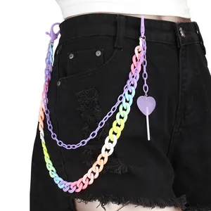 Macro detail of rainbow acrylic layered pants chain with purple heart lollipop charm