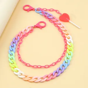Detail of colorful macaron resin trousers chain with heart lollipop charm and pink clasps