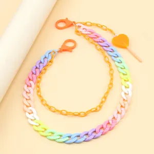 Detail of colorful resin pants chain with double layer design and heart lollipop pendant
