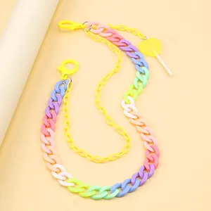 Rainbow acrylic pants chain with yellow lobster clasps and a heart lollipop charm detail