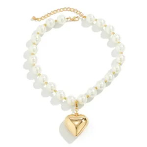 Chunky faux pearl necklace with large polished gold heart pendant and adjustable clasp