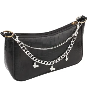 Black crocodile pattern baguette bag with silver butterfly chain charms on white background