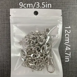 Silver metal star pants chain with lobster clasp shown in clear product packaging
