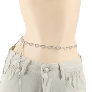 Cinturón plateado ajustable con corazones de strass sobre pantalones vaqueros