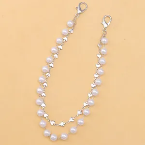 Detail of beaded bag chain with faux pearls, silver heart charms and lobster clasps