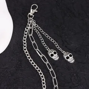 Detail view of double-layered punk waist chain with silver skull charms and lobster clasp