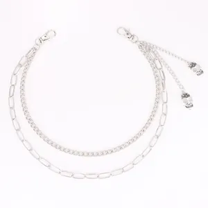 Detail of double-layer punk waist chain with silver skull pendants and lobster clasps