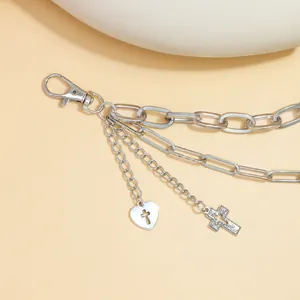 Close-up of hip hop silver multilayer trousers chain with cross and heart pendants