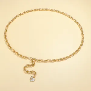 Detail of gold metal waist chain featuring a heart pendant and adjustable lobster clasp