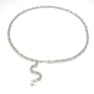 Detailed close-up of silver woven metal waist chain with pearl heart pendant