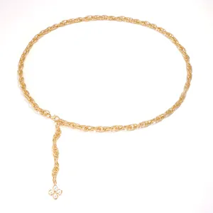 Elegant gold chain belt with pearl heart and four-leaf clover pendant on white background