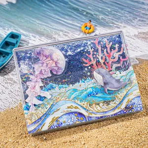 Ocean themed acrylic shaker card with blue quicksand, jellyfish and whale illustrations