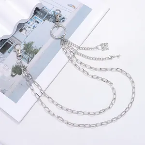 Detail of silver double layer trouser chain with skull key and rhinestone lock pendant