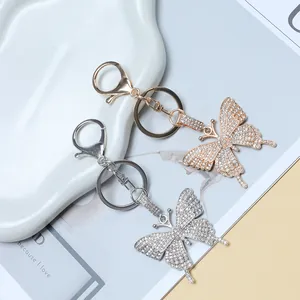 Detailed close-up of sparkling butterfly keychain with rhinestones in gold and silver