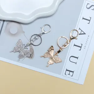 Close-up of butterfly keychains featuring rhinestone accents and textured metal finishes
