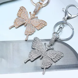 Close-up of sparkling rhinestone butterfly keychains in rose gold and silver finishes