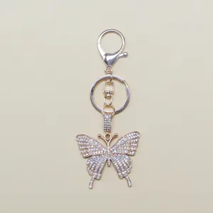 Close-up of alloy butterfly keychain with sparkling white zircons and lobster clasp detail
