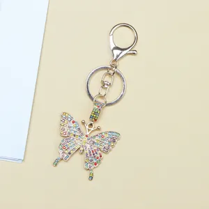 Close-up of colorful rhinestone butterfly keychain with golden lobster clasp and ring