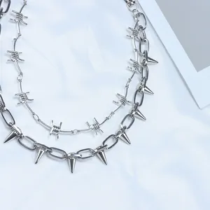 Macro detail of double-layer punk metal pants chain with barb and spike pendants