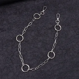 Silver multi-ring metal pants chain with oval links and large hollow circles on black background