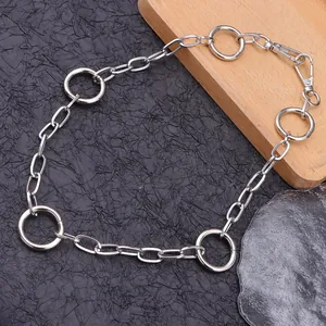 Chunky silver circular link chain belt with lobster clasp on dark textured background