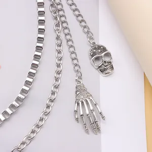 Double-layered punk chain necklace featuring realistic skull and skeleton hand pendants