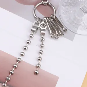 Minimalist silver bead chain ring accessory with industrial metal links on a stylish background