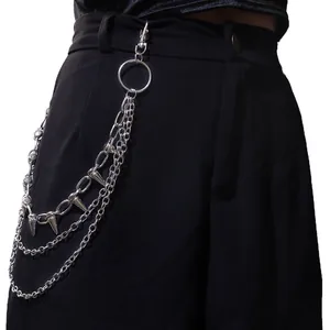 Detail of multi-layered silver metal hip-hop pants chain with punk spikes on black trousers