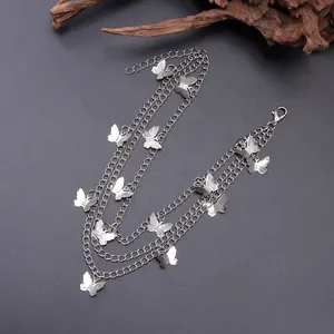 Close-up of triple-layered silver metal shoe chains with detailed butterfly pendants
