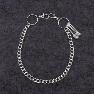 Close-up of silver metal hip hop pant chain with three detailed skull pendants