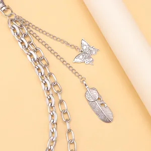 Detail of silver multilayer pant chain featuring metal feather and butterfly charms