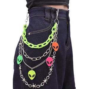 Multi-layer waist chain with neon green link and colorful alien pendants on denim