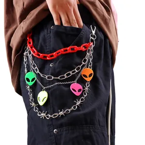 Detail of multi-layer punk waist chain with colorful alien pendants and metal links