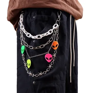 Detail of multi-layer punk pants chain with colorful alien pendants and barbed wire link