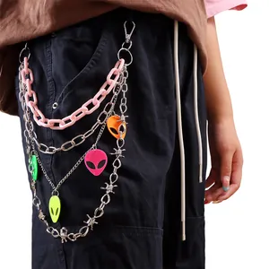 Detail of multi-layer pants chain with colorful alien pendants on pink plastic links
