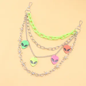 Detail of multi-layer pants chain featuring neon plastic links and acrylic alien pendants