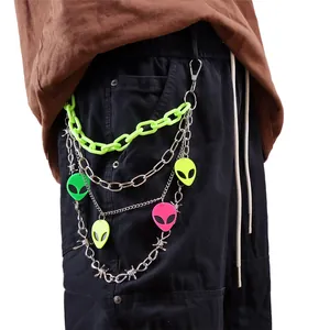 Detail of neon green plastic chain and metal thorn chains with colorful alien charms