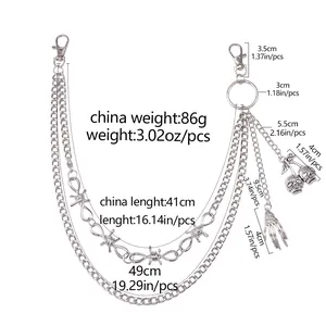 Detail showing skull and bone hand charms on multi-layer punk metal trousers chain