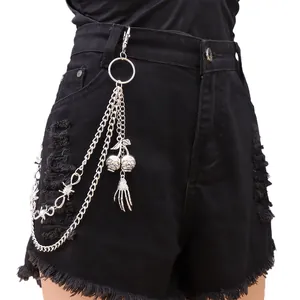 Punk metal wallet chain with skull charms and double layer thorns on black denim shorts